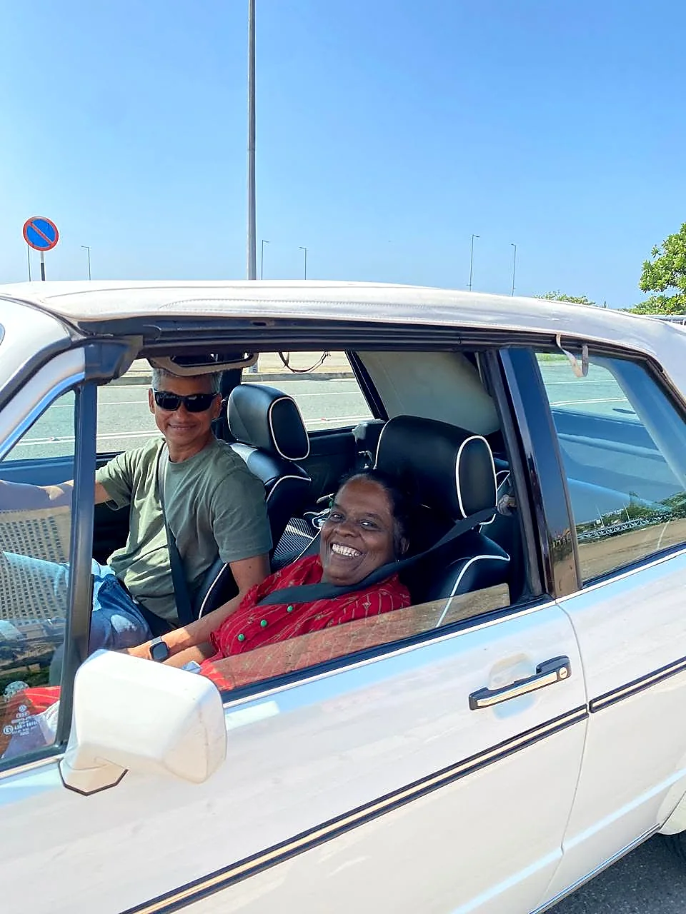 A resident smiling during a classic car outing