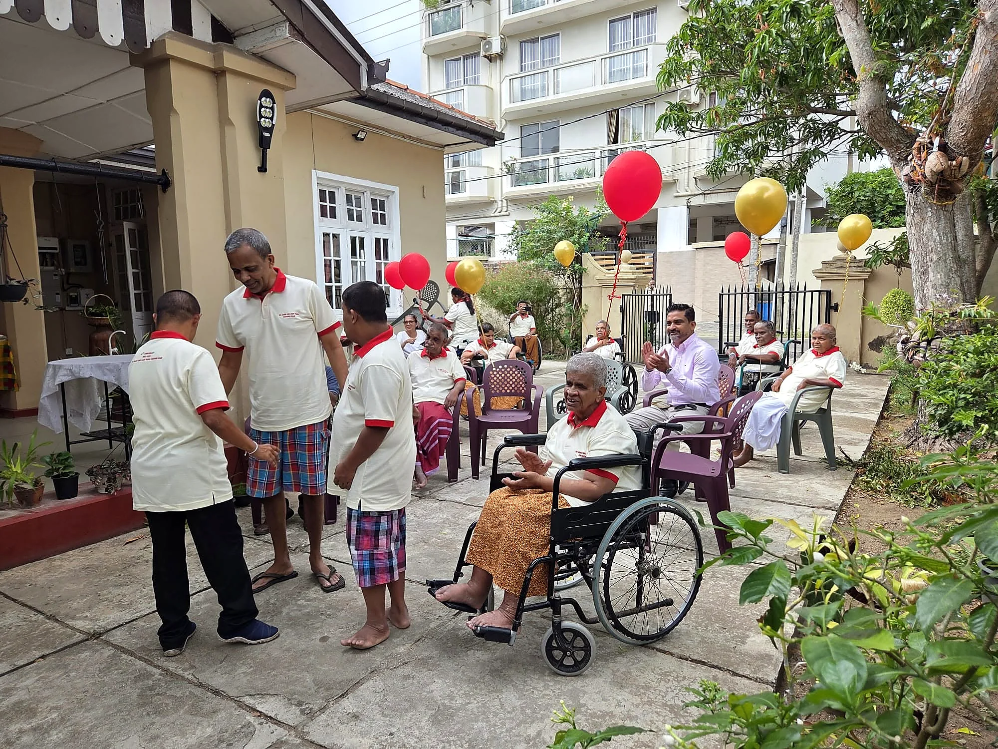 Residents celebrating outdoors with anniversary balloons